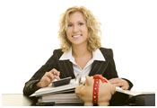 Image of woman at desk using calculator