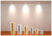 Image of stacks of coins under spotlights