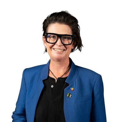 Professional headshot of Lisa Wade in a blue jacket and dark rimmed glasses.