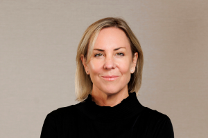 Head-and-shoulders professional portrait of Jane Franks wearing a collared shirt and blazer, facing the camera against a plain light background