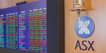 ASX pricing board next to ASX logo and listings bell