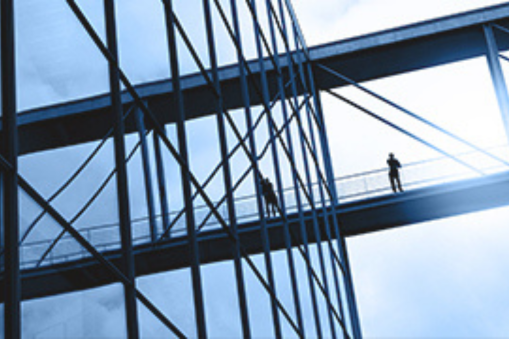 Close-up of metal framework against a bright sky
