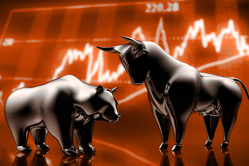 Metallic bull and bear figures positioned in front of an orange chart background
