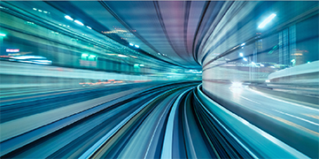 Blurred view through a tunnel‑like space with light streaks suggesting forward movement