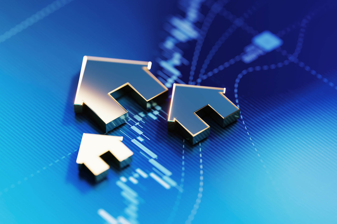 Metallic arrows in the shape of a house pointing up on digital financial chart