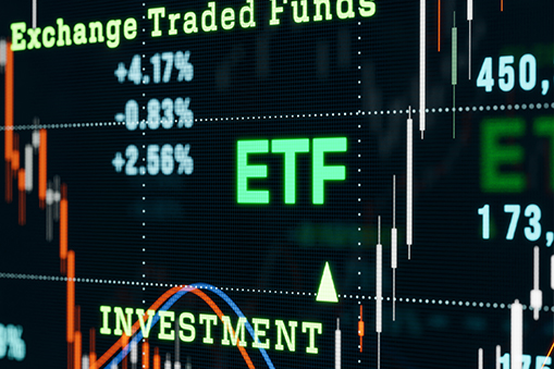 The image shows a digital financial market display emphasizing the term ETF in bright green letters.