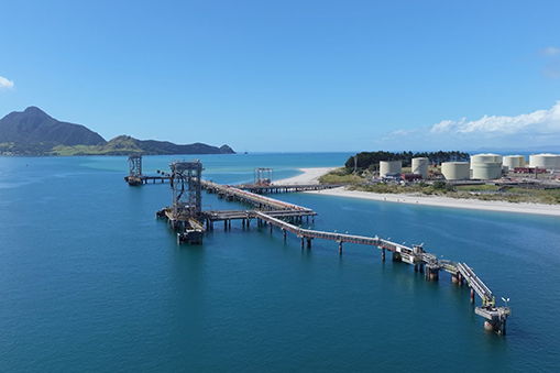 Coastal industrial pier extending into blue sea