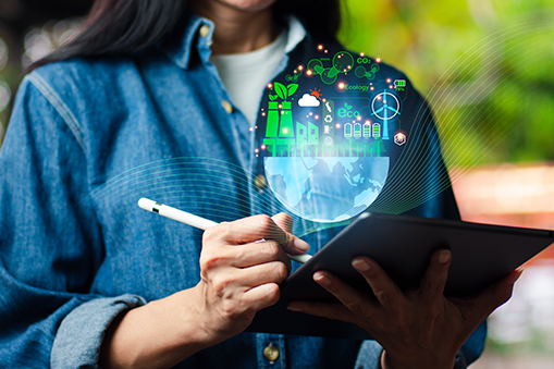 Woman using tablet with sustainable technology hologram