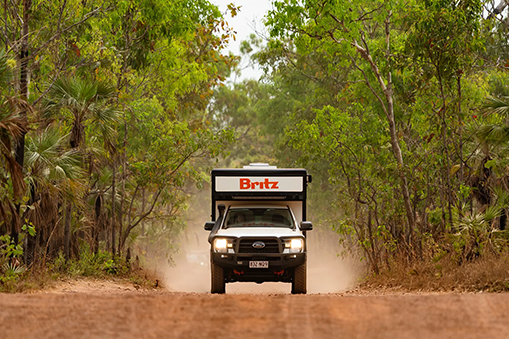  Britz camper van driving through forest trail