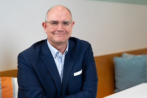 Grant Webster in formal attire seated indoors