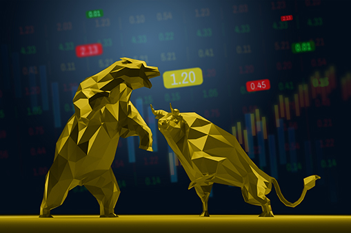 Golden bull and bear statues with stock market data