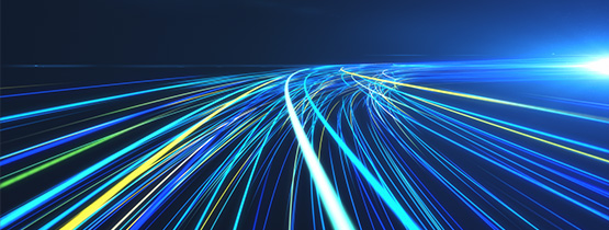 Abstract image of curved blue, green, and white light trails converging toward a bright point on a dark background.