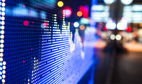 Digital display of coloured light patterns resembling market data, shown as part of a course card titled ETFs and ETPs with descriptive text and a See more button