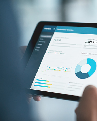 Tablet screen displaying a dashboard with charts, graphs and summary metrics.