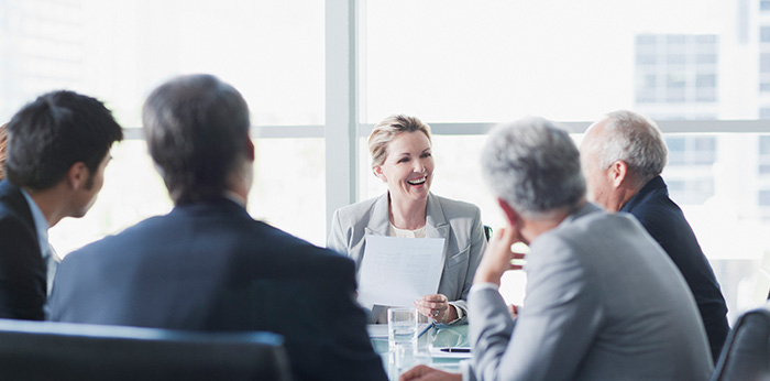 Group of people seated around a meeting table in an office