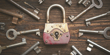 Keys pointing towards a padlock.