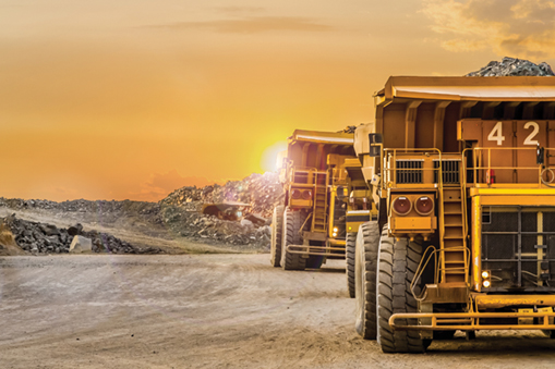 Mining road with two large mining trucks on the right